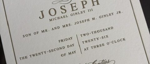 Letterpress wedding invitation with a blind-embossed Cleveland skyline