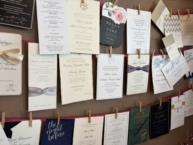 Wall of wedding invitation samples at Paper Trails of Rocky River